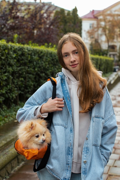 Front view girl carrying bag with dog