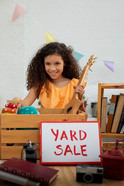 Free Photo front view girl at garage sale