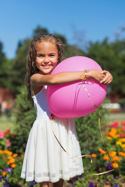 Free photo front view of girl holding balloon