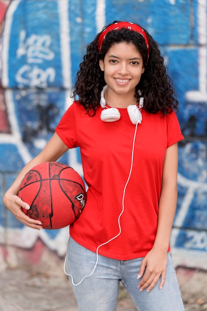 Free photo front view girl holding basket ball