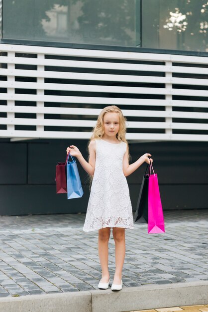 Front view girl holding shopping bags