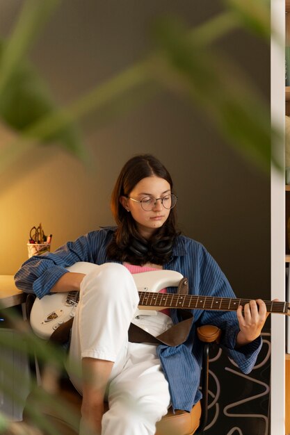 Front view girl playing the guitar