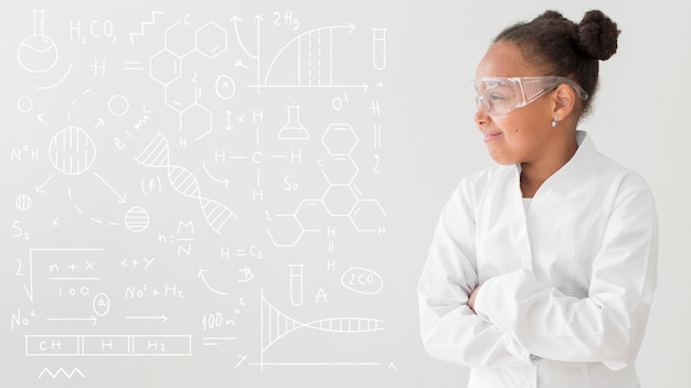 Free photo front view of girl scientist posing with lab coat and safety glasses