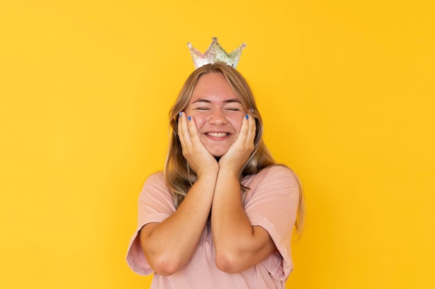 Free photo front view of girl wearing a crown with copy space