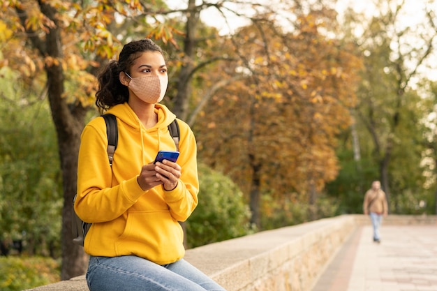 Front view of girl with face mask on street