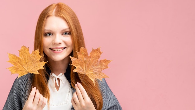 Free photo front view girl with yellow leaves