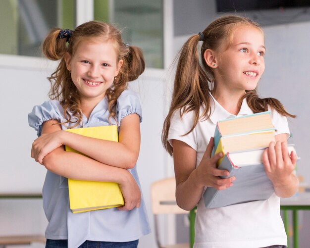 Front view girls holding books in class