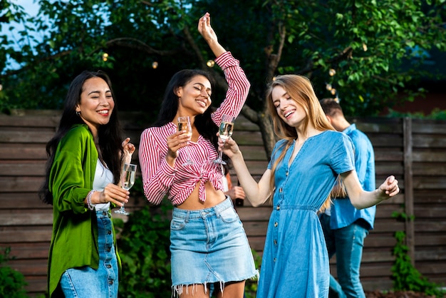 Front view girls with drinks dancing