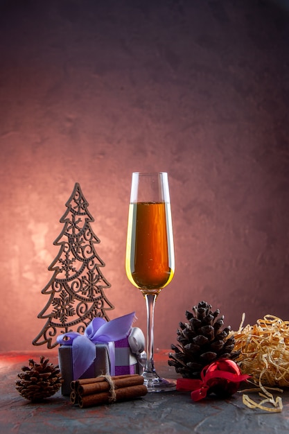 Front view glass of champagne with present and toys on light drink alcohol photo color champagne new year