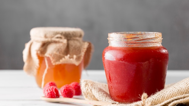 Front view of glass jars with raspberry jam