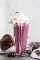 Free photo front view of glass with dessert and whip cream