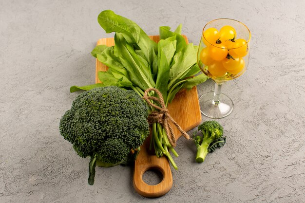 front view green broccoli greens fresh on the brown desk on the bright