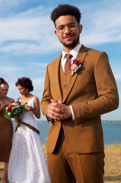 Free Photo front view groom and bride posing in nature