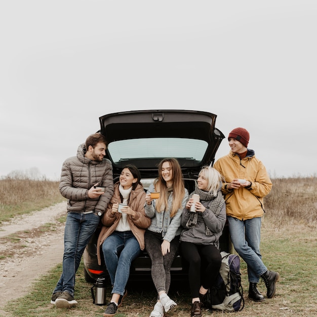 Front view group of friends on road trip break