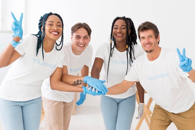 Front view group of volunteers holding hands