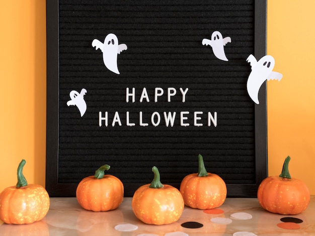 Free photo front view halloween concept with greeting