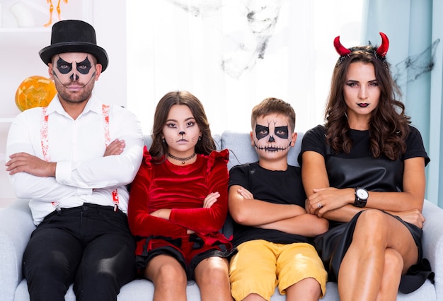 Free photo front view halloween family looking at camera