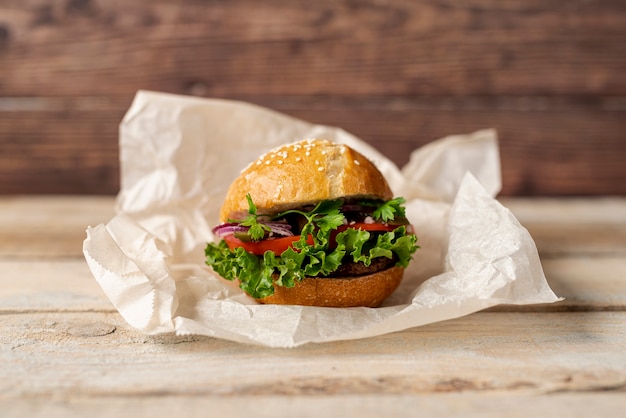 Front view hamburger with wooden background