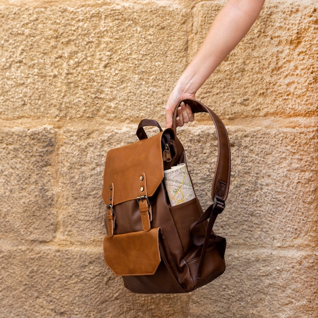 Front view hand holding backpack