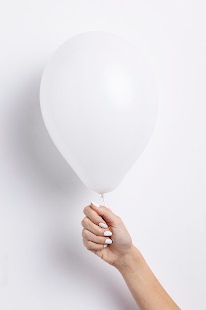 Free Photo front view of hand holding balloon