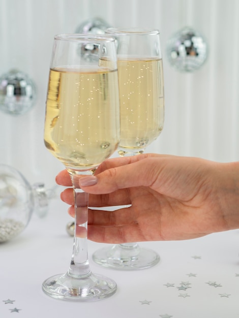 Front view of hand holding champagne glass