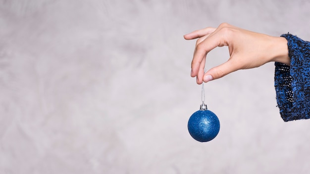 Front view hand holding christmas ball