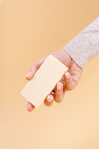 Free Photo front view of hand holding one piece of wafer with copy space