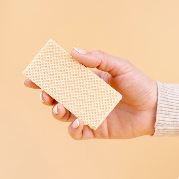 Free Photo front view of hand holding one piece of wafer