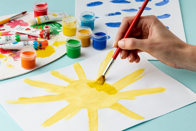 Free Photo front view of hand painting a sun