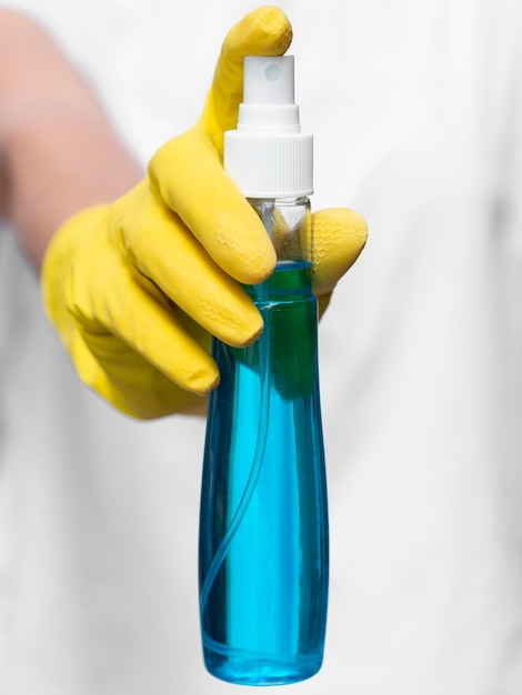 Free Photo front view of hand with surgical glove holding alcohol bottle