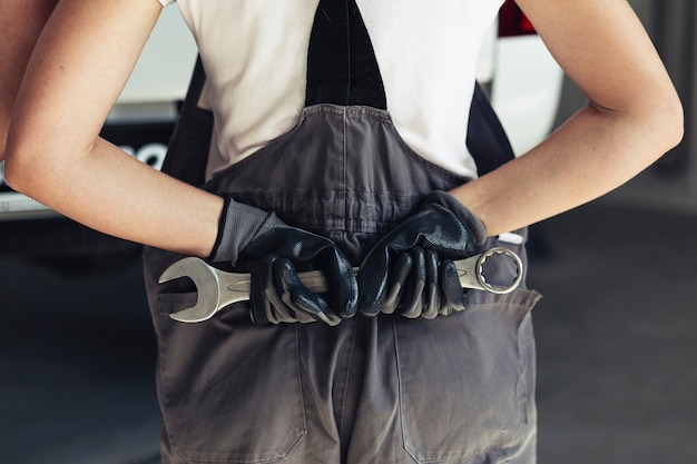 Free Photo front view hands holding wrench