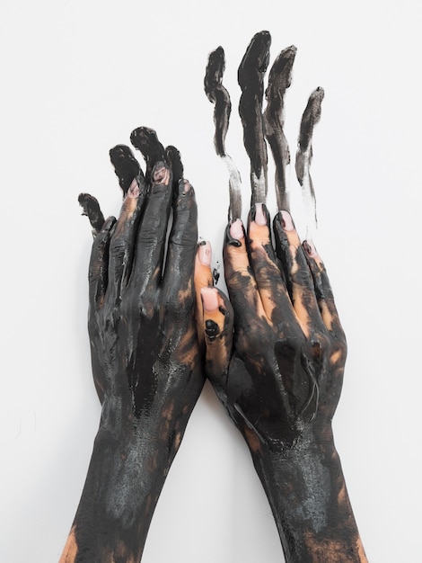 Front view of hands painted with black paint