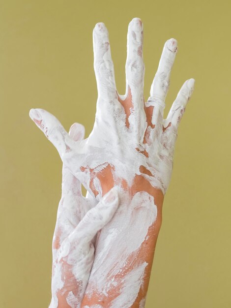 Front view of hands painted with white paint