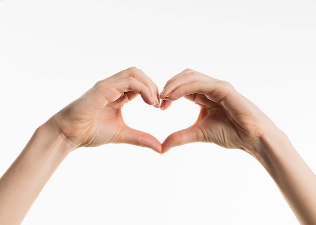 Free photo front view of hands showing heart sign