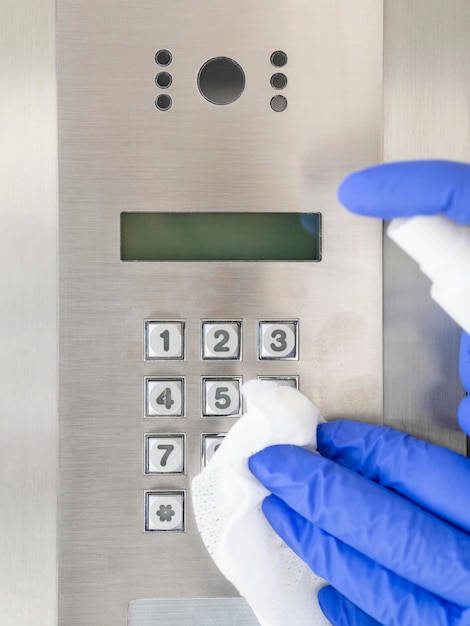 Front view of hands with surgical gloves disinfecting device