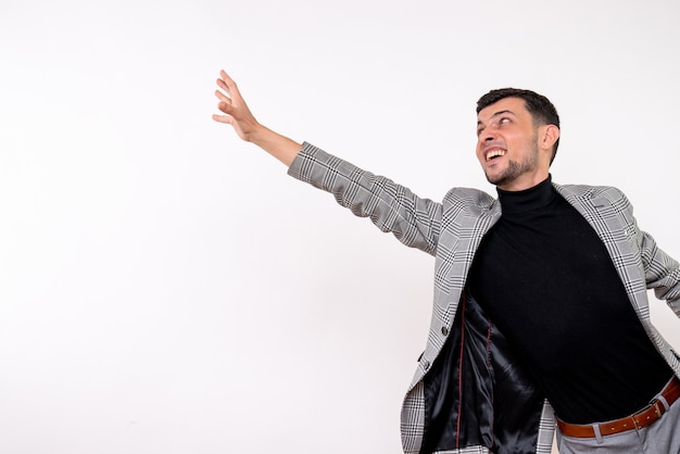 Front view handsome male in suit trying to catch something standing on white background