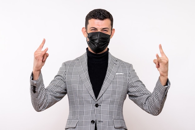 Front view handsome man in suit making wolf sign standing on white isolated background