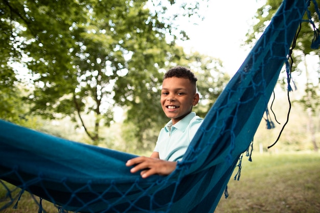 Front view of happy boy in hammock