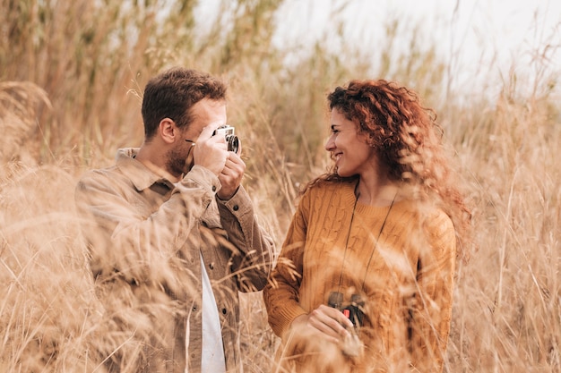 Free photo front view happy couple in wheat field