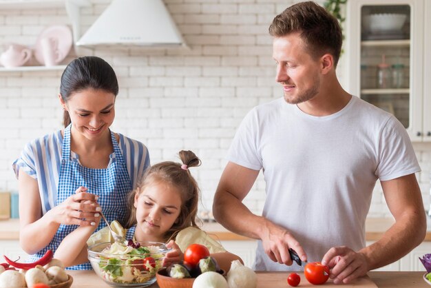 Front view happy family cooking together