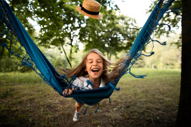 Free Photo front view of happy girl in hammock