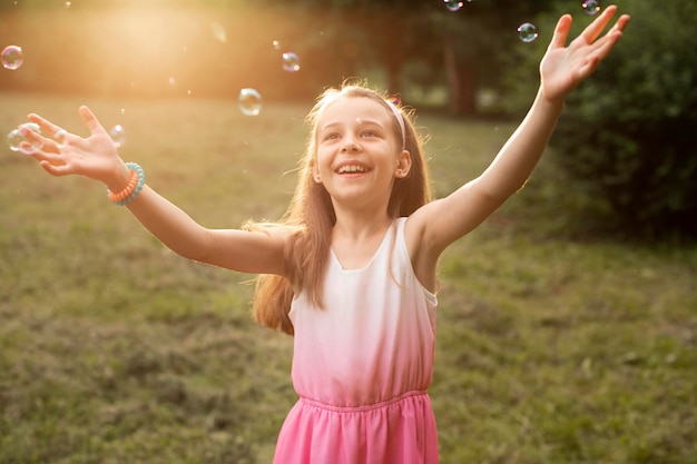 Front view of happy girl in park