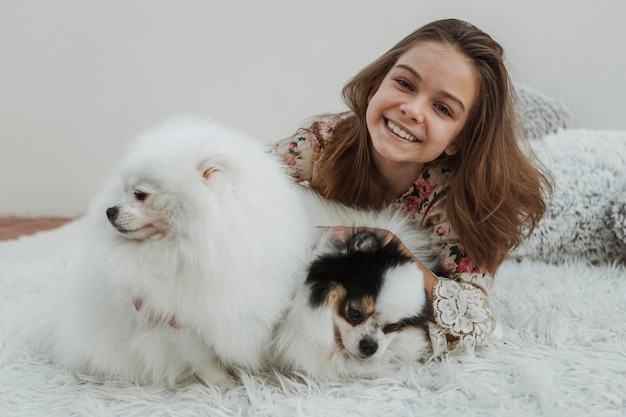 Front view happy girl and two fluffy dogs