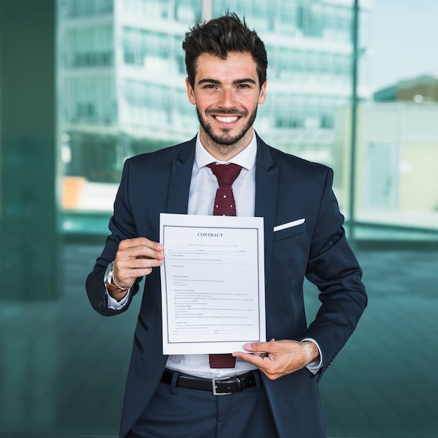 Front view happy man holding a contract