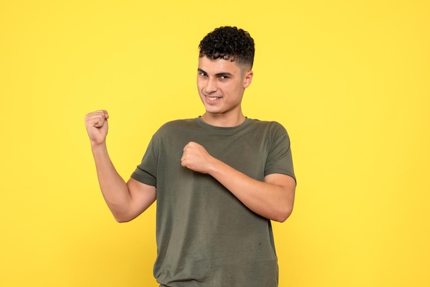 Front view of happy smiling man looking forward clenching his fists