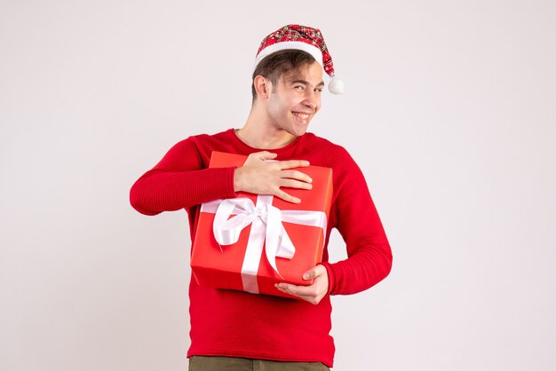 Front view happy young man with santa hat standing on white 