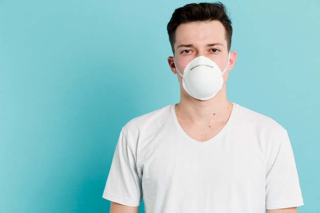 Front view of ill man wearing a medical mask