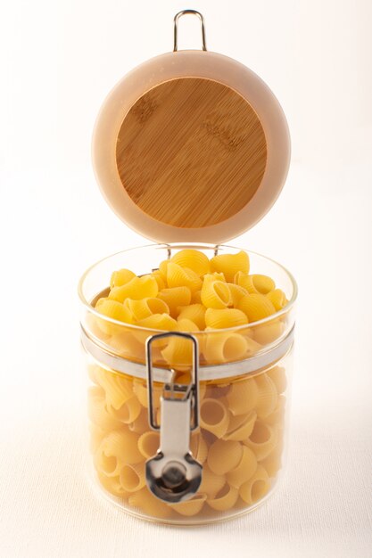 A front view italian dry pasta raw yellow pasta inside bowl on the white