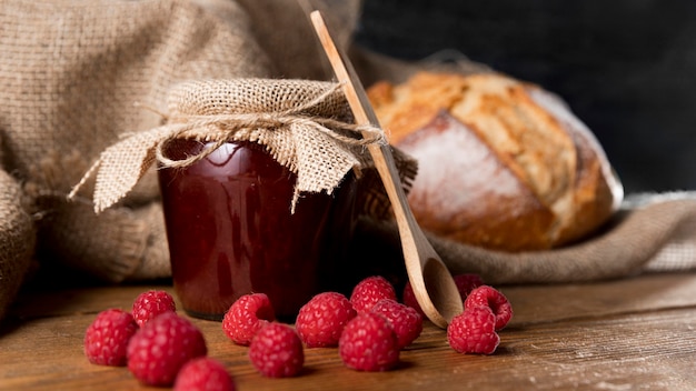 Front view of jam jar with raspberries