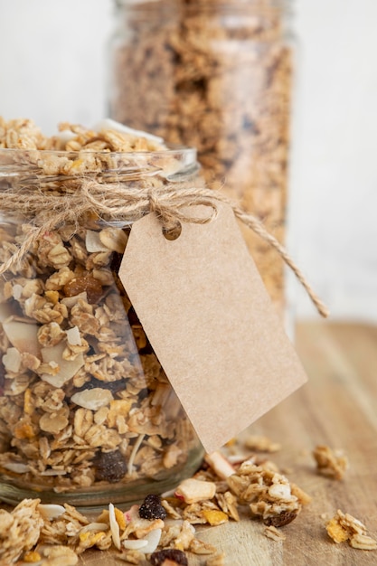 Free Photo front view of jars with breakfast cereals and tag